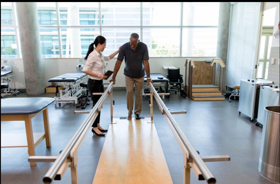 Physiotherapist assisting a patient with hemiparesis during gait training at Aarav Healthcare